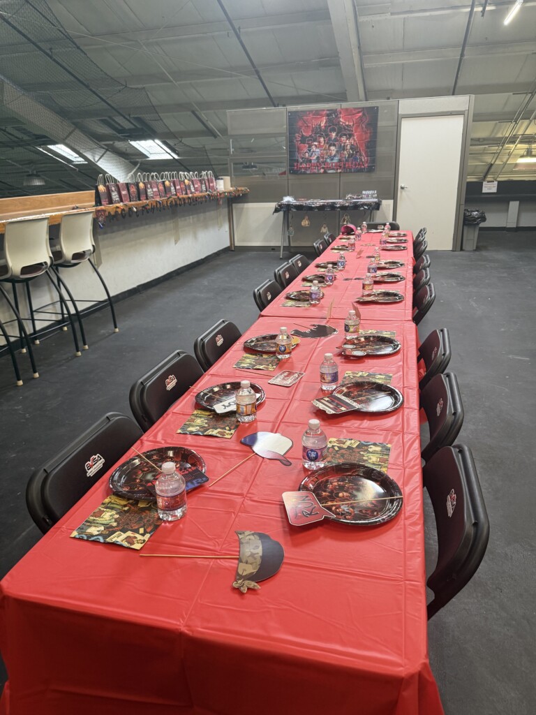 Full Stranger Things-themed party table with custom place settings and decorations at BVSA