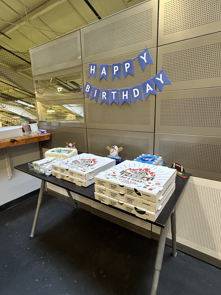 Birthday food and cake table with a Happy Birthday banner at BVSA