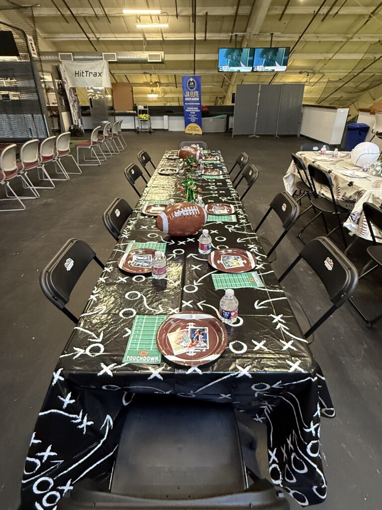 Football-themed birthday party table with field decorations and custom place settings at BVSA