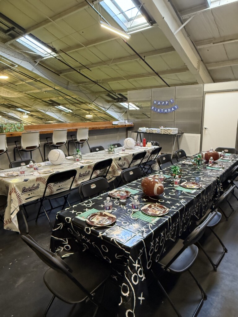 Wide view of a complete baseball and football birthday party room setup at BVSA